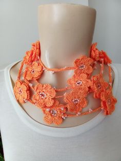 The extra long crochet necklace adorned with orange flowers and beads is suitable for hand washing. Its length is 88.5 inches and is a nice gift for mothers and lovers. Orange Necklace For Spring Gift, Orange Necklace For Spring Season Gift, Orange Long Necklace Gift, Orange Flower Shaped Beaded Necklace For Gift, Orange Flower Jewelry For Beach, Bohemian Orange Flower Beaded Necklace, Orange Flower Beaded Necklace, Handmade Orange Flower Necklace, Adjustable Long Orange Necklace