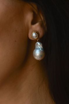 These white and gold earrings feature a beautiful 13-17 mm large white baroque pearl delicately dangling from a circle crafted from brass and plated with 14k gold. Another white pearl is elegantly positioned within the circle. These dainty pearl earrings offer a delicate and minimalist design that effortlessly complements any outfit. These versatile and stylish earrings are ideal for both formal events and everyday wear. Elegant White Plug Earrings, Elegant White Round Plug Earrings, Formal White Drop Earrings, White Round Plug Earrings For Formal Events, White Round Plug Earrings For Formal Occasions, Elegant White Plug Earrings With Ear Wire, Elegant Pearl Drop Plug Earrings, Statement Bridal Earrings, Dainty Pearl Earrings