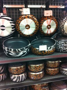 several pots and pans are on display in a store shelf with other items behind them