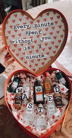 a heart shaped box filled with lots of bottles