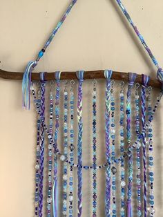 a wall hanging made out of beads and wood