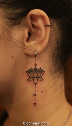 a woman with a tattoo on her neck and behind the ear is a lotus flower