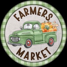 a green truck with pumpkins in the back and farmer's market sign above it