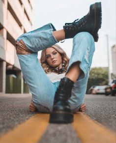 a woman laying on the ground with her legs crossed