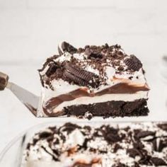 a piece of ice cream cake with oreo cookies on top is in a pan