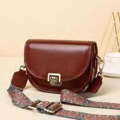 Deluxe Ladies' Soft Leather Crossbody Purse with Distinctive Clasp Feature Woyaza Classic Brown Satchel With Buckle Closure, Trendy Brown Leather Flap Bag, Brown Saddle Bag With Adjustable Strap For Office, Leather Saddle Shoulder Bag With Buckle, Leather Saddle Shoulder Bag With Buckle Closure, Brown Office Saddle Bag With Adjustable Strap, Trendy Brown Satchel With Strap, Brown Leather Saddle Bag With Hasp Closure, Brown Flap Saddle Bag With Adjustable Strap