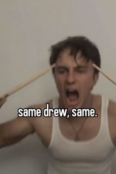 a man holding two wooden sticks over his head with the words same drew, same