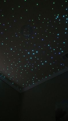 the ceiling is covered in blue and green lights that are shining down from the ceiling