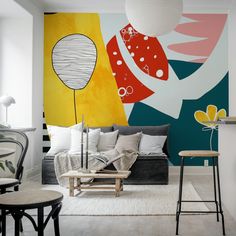 a living room filled with furniture next to a painting on the side of a wall