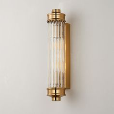 a wall mounted light on the side of a white wall