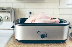 a chicken is sitting in an oven on the counter