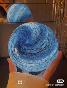 a hand holding a blue and white spinning ball