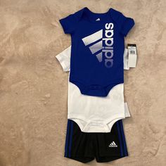 Adidas 3 Piece Outfit Size 9 Months. Outfit Includes: Two Short Sleeve Onesies And Shorts. One Blue Onesie, One White Onesie And Black Shorts. Brand New! White Stretch Playwear Sets, Adidas Fitted Sets For Playwear, Adidas Fitted Playwear Sets, Fitted White Adidas Sets, Sporty White Playtime Sets, Baby Boys Outfit, Toddler Adidas, Adidas Set, Adidas Baby