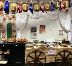 an assortment of breads and pastries are on display in a room with white drapes