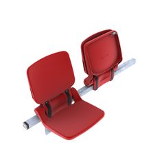 two red seats sitting next to each other on top of a metal bar with wheels