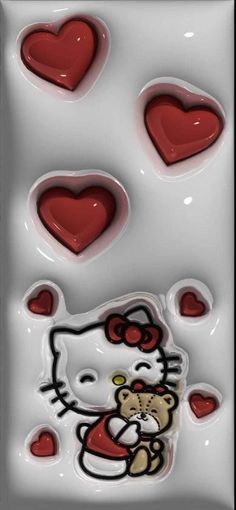 a hello kitty chocolate mold with hearts on the bottom and an image of a teddy bear in the middle