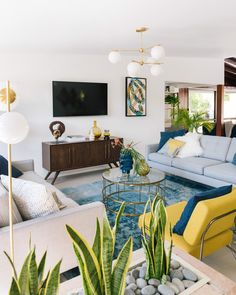 a living room filled with furniture and plants