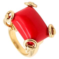 Cocktail ring designed by Gucci. Iconic and popular horse-bits cocktail ring, created in Milano Italy by the fashion and jewelry house of Gucci. This large cocktail ring has been crafted in solid yellow gold of 18 karats with high polished finish. The setting is designed, with horse bits patterns that are holding on top a large carved coral. Coral: Mounted in the center, with 1 rectangle cabochon cut (15.5 x 20.3 x 11.5 mm) of a red coral of 24.45 carats. Weight: 24.65 Grams, (15.81 Dwt). Size: 6.5 and can be sized. Measurements: 26 mm by 21 mm (1.02 x 0.83 Inches) and raise 15 mm over the finger. Hallmarks: Stamped with the maker's mark, the Italian gold assay mark and signed in full, "GUCCI MADE IN ITALY .750 10 *3749AL". Gucci This company was founded in 1921 in the Tuscany region of It Aldo Gucci, Cocktail Ring Designs, League Of Nations, Milano Italy, Gucci Horsebit, House Of Gucci, Horse Bits, Leather Luggage, The League