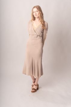 Stunningly preserved 1920’s mauve & ecru bias cut dress with attached jacket, lace trim, and asymmetrical cut. Best fits modern size S-M Length 52”Pit to pit 18.5”Waist 26-30”Hips 31-42” Model’s Measurements:Height 5’9”Chest 34”Waist 29”Hips 36.5” Excellent vintage condition, with normal wear and condition for its age.For international shipping rates, please send inquiries to our CONTACT page. Fitted Bias Cut Midi Dress For Daywear, Fitted Feminine Rayon Midi Dress, Taupe Fitted V-neck Dress, Fitted Rayon Dresses With Bias Cut, Fitted Rayon Dresses In Bias Cut, Fitted Bias Cut Dresses In Rayon, Fitted Bias Cut Rayon Dresses, Fitted Vintage V-neck Dress For Daywear, Fitted V-neck Vintage Dress For Daywear