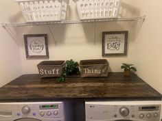 a washer and dryer sitting next to each other on top of a wooden counter