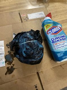 a close up of a bottle of cleaner next to a moldy object