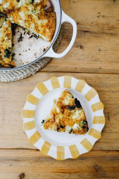 a slice of pizza on a plate next to a casserole dish