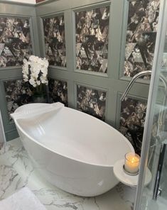 a white bath tub sitting inside of a bathroom