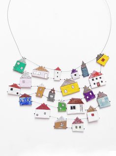 a group of small houses hanging from a string