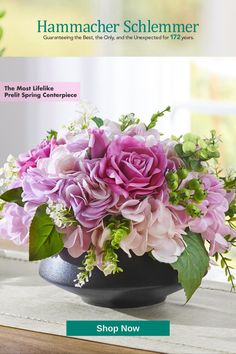 a vase filled with pink flowers on top of a table