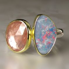 Lovely Australian Boulder Opal Doublet(7 X 12.2mm, 1.70cts) paired with a beautiful rose cut pink sapphire(2.63cts, 8.1 X 10.2mm). Each stone is set in a solid 18k gold bezel with fine silver backsheets under the stones. sterling silver band- approx. 2.9mm wide. All metal is from recycled sources. This ring is a size 7 1/2 and I can stretch to a 7 3/4. Photos have been taken up close for detail. Please refer to dimensions. Attractively boxed. Custom rings are available. Convo me for information. Pink Opal Gemstone Ring For Anniversary, Pink Sapphire Ring With Gemstone Accents As A Gift, Pink Opal Ring For Anniversary, Fine Jewelry, Pink Opal Ring For Anniversary, Elegant Pink Opal Ring, Elegant Pink Opal Ring In Sterling Silver, Elegant Pink Opal Sterling Silver Ring, Elegant Pink Opal Gemstone Ring, Original Engagement Rings