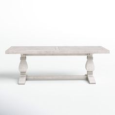 a white table sitting on top of a wooden floor