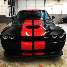 a black and red car parked in a garage