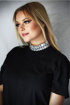 This chunky rhinestone choker necklace is a stunner. The oversized rhinestones reflect the light in the most beautiful way letting all around see you shine.   This choker-length necklace is 12 and 1/2 inches long and 1 and 3/8 inches wide with a 3 and 1/2 inch extender chain. It is made with alternating oblong and rectangular oversized acrylic rhinestones in silver tone settings. This beautiful necklace feels right at home on the runway or at the club, but you can wear it anywhere you want to tu Rhinestone Jewel Choker Necklace, Rhinestone Jeweled Choker Necklace, Dazzling Rhinestone Choker Necklace For Party, Dazzling Rhinestone Choker For Party, Glamorous Silver Bling Choker, Glamorous Party Choker With Sparkling Stones, Dazzling Crystal Rhinestone Choker Necklace, Dazzling Rhinestone Choker Necklace, Glamorous Choker With Sparkling Stones