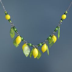 "This Lemon necklace is made of glass in the lampwork technique. This glass fruit necklace is stylish and elegant and will become a bright addition to your outfits! 💕 You will definitely look stunning in this citrus necklace! Dimentions: the necklace length is adjustable, 16\"-19\" inch (40-48cm). The silver colored chain is made of stainless steel and is hypoallergenic. Materials: artist lampwork glass beads, stainless steel and metal fittings. 🎁 This statement yellow necklace will also be a Green Glass Pendant Jewelry, Green Glass Pendant Necklace, Lemon Necklace, Fruit Necklace, Frutiger Aero, Miniature Food Jewelry, Glass Fruit, Fruit Jewelry, Yellow Necklace