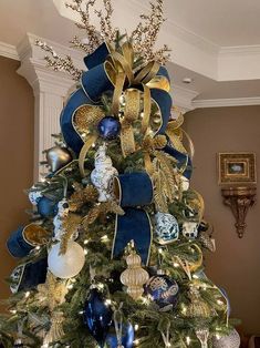 a christmas tree with blue and gold decorations