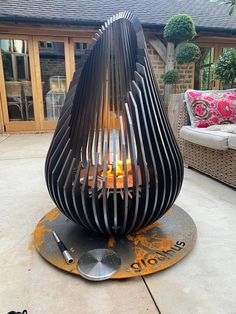 an outdoor fire pit sitting on top of a patio