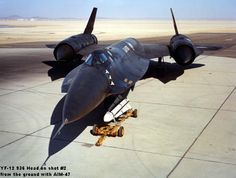 an air force jet sitting on top of an airport tarmac