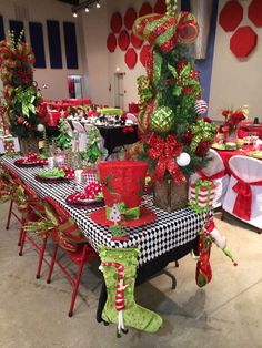 the table is decorated with christmas decorations and gifts for everyone to have at this party