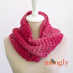 a pink knitted scarf sitting on top of a mannequin