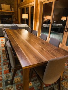 a large wooden table with chairs around it