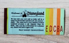 a disney land ticket sitting on top of a wooden table