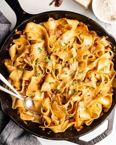 a skillet filled with pasta and meat