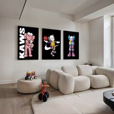 a living room filled with furniture and two pictures on the wall above each couches