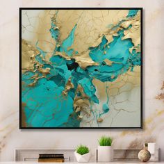 an abstract painting in gold and blue on a white wall above a fireplace mantel