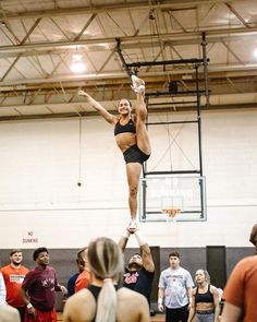 a woman is doing tricks on the basketball court