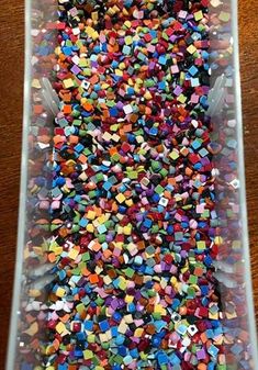 a plastic container filled with lots of colorful sprinkles