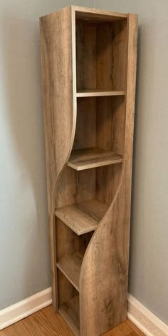 a curved wooden shelf in the corner of a room