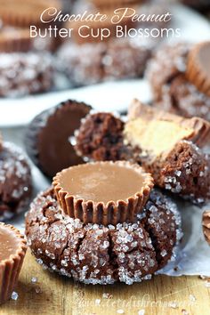 chocolate peanut butter cup blossoms on a cutting board with other desserts in the background