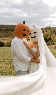 a bride and groom dressed up as pumpkins