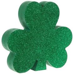 a green glittered shamrock shaped object on a white background